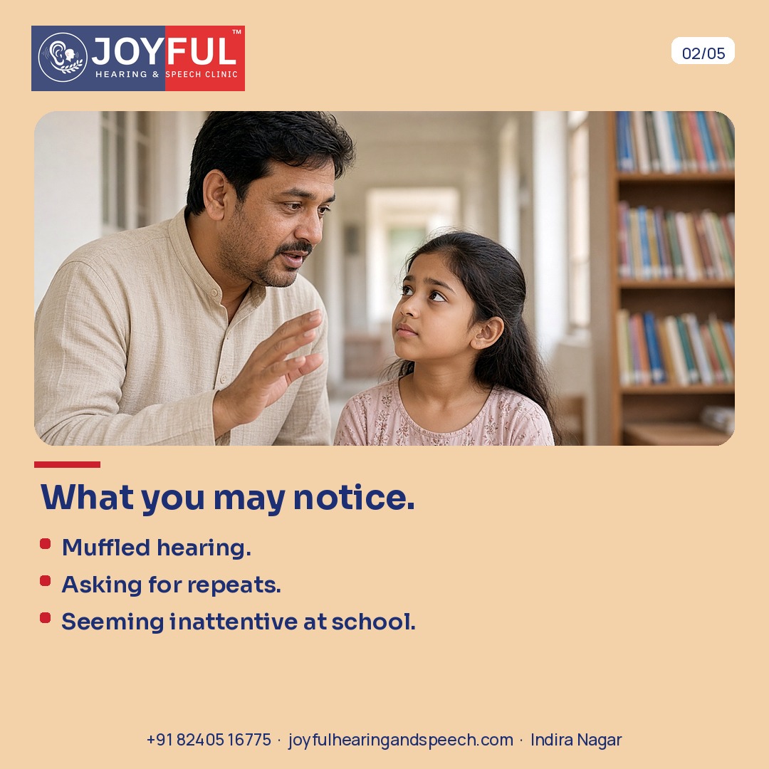 A father speaks with his daughter near bookshelves. Muffled hearing, asking for repeats, seeming inattentive at school.